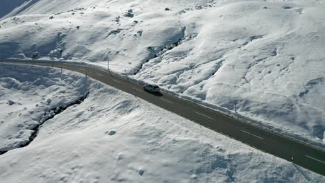 left-to-right-pan-following-a-car-on-the-snowy-mountain-road