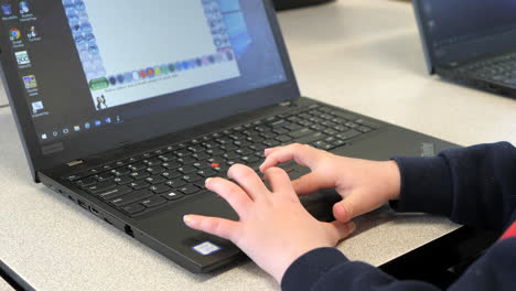 Student-Using-A-Laptop-Computers-Trackpad-In-Class,-CLOSE-UP