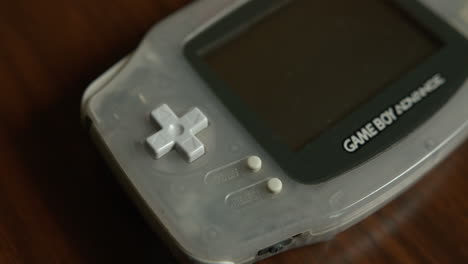 Left-Side-Close-Up-Tilt-of-a-Game-Boy-Advance-on-a-Table