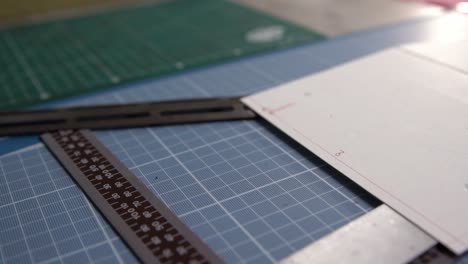 Cutting-table-for-leather-segments-showing-cutting-guides,-mats-and-guides-,-Dolly-out-close-up-shot