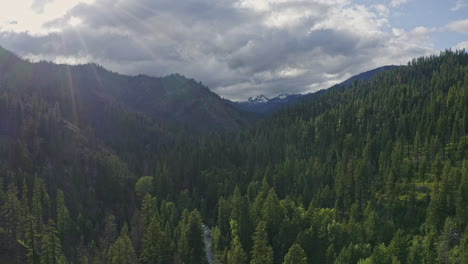 Teanaway-Forest-Washington-Aerial-v4-dolly-in-shot-of-sunrays-over-Cascade-Mountains-and-wild-forest---June-2020
