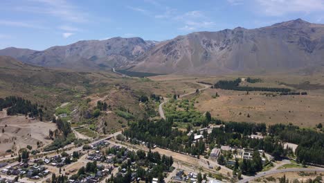 Dolly-in-over-Esquel-town-surrounded-by-woods-and-Andean-mountains,-Patagonia-Argentina