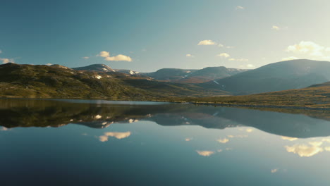 The-beautiful-calmness-of-the-Vavatnet-lake-and-mountains-in-Hemsedal-in-Norway-during-sunrise---aerial