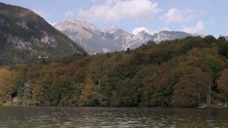 The-sun-appearing-on-the-fall-colours-at-Lake-Bohinj-showing-the-stunning-colours-with-the-alps-in-the-background-and-lake-in-the-foreground