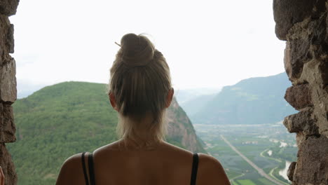Young-pretty-girl-enjoying-beautiful-landscape-view-over-italian-mountains-and-nature