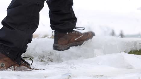 hiking-boots-smashing-through-thin-layers-of-ice-super-slomo