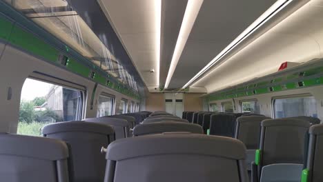 A-view-of-an-empty-UK-train-travelling-with-a-view-from-within-a-train-carriage