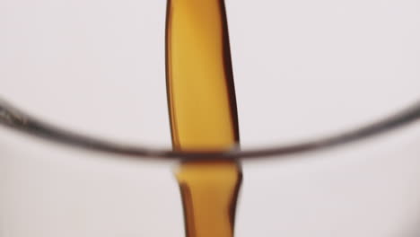 Extreme-close-up-of-coffee-getting-poured-into-a-glass