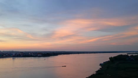 Sunset-with-pinkish-clouds,-aerial-flyover-the-mighty-Mekong-river