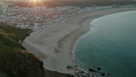 View-From-The-Viewpoint-Of-Nazaré-Beach-At-Sunrise-In-Portugal---aerial-drone-shot