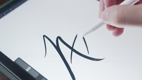 Close-Up-of-a-Man-Digitally-Drawing-the-Word-Art-on-a-Touchpad-Screen