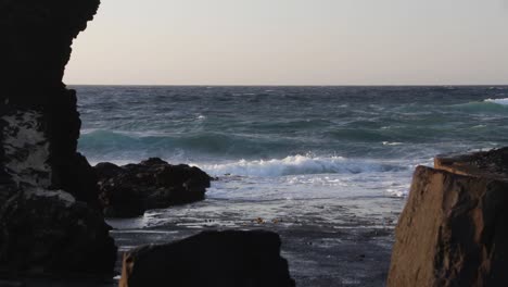 Ocean-waves-during-the-blue-hour-at-Playa-de-Las-Americas,-Tenerife