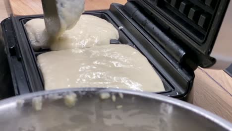 Making-Waffles---Pouring-Waffle-Batter-Into-A-Waffle-Maker---close-up,-slow-motion