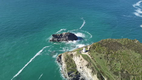 Gull-Rock-Surrounded-By-Turquoise-Blue-Sea-In-Portreath-Cornwall-With-View-Of-Pepperpot-On-A-Summer-Day---aerial