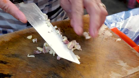 Old-Hands-Chop-Garlic-at-Open-Air-Kitchen---CloseUp