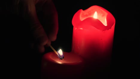 Man-lighting-candle-in-the-darkness