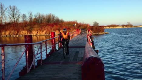Hand-held-floating-bridge-shot-with-approaching-cyclist-crossing-frame