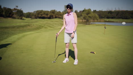 Young-female-golfer-putting-on-a-sunny-day