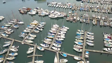 4K-Drone-Flying-over-Boat-Club-showing-Boats-and-Sailboats-in-Vancouver,-Canada