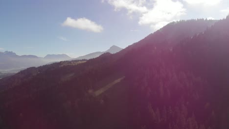 AERIAL:-Pan-shot-of-landscape-of-the-alps-with-mountains-and-forest