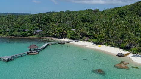 Backwards-Aerial-of-a-perfect-tropical-private-beach-in-Asia