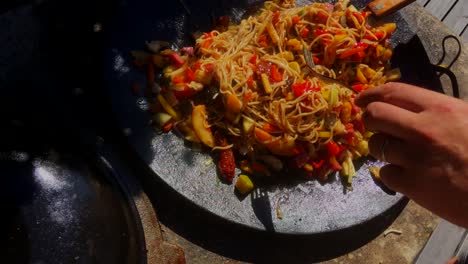 delicious-wok-being-cooked-outside-in-a-big-pan