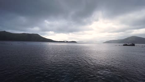 Panorama-view-of-ocean,-New-Zealand-greenshell-mussel-farms,-bays,-hills,-sky,-clouds-and-sun