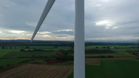 Slow-close-ascending-shot-of-wind-turbine-in-British-countryside