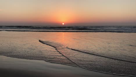California-sunset-reflecting-off-the-sand-during-low-tide-in-San-Diego,-California