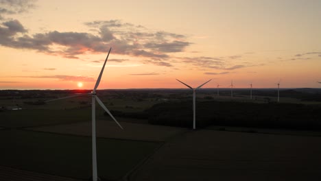 Flying-behind-wind-turbines-on-green-fields