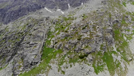 AERIAL:-Steep-Side-of-a-Mountain-covered-with-Green-Grass