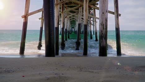 Time-lapse-of-waves-under-pier-in-New-Port-Beach,-California