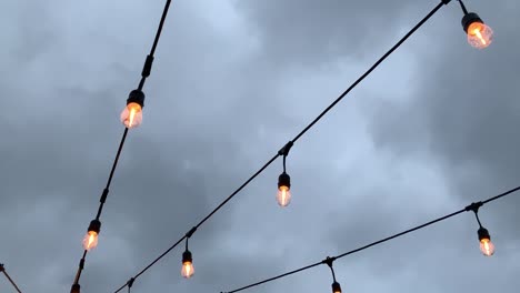 Outdoor-patio-lights-illuminating-the-sky-on-a-rainy-gloomy-evening