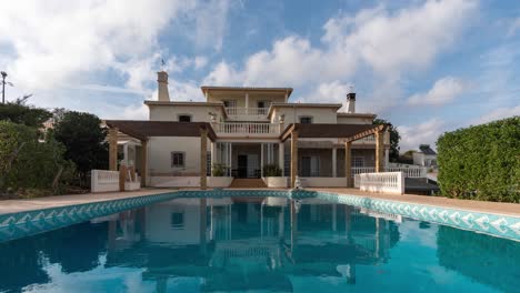 big-house-with-swimming-pool-cloudy-wind-time-lapse