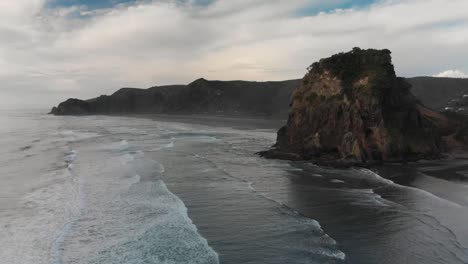 Aerial-drone-shot-of-Piha-Beach-and-Lion-Rock-in-New-Zealand