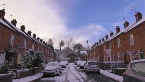 Quaint-slow-motion-shot-of-a-village-street-with-terrace-cottages-during-the-snow