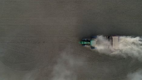 Drone-footage-of-green-tractor-working-in-a-fields