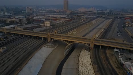 Aerial-clip-from-drone-flying-down-the-LA-River,-Downtown-LA