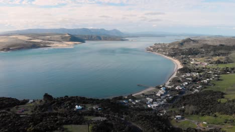 Aerial-view-flying-backwards-over-Omapere,-New-Zealand