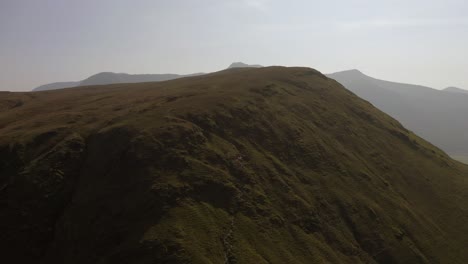 Drone-waterfall-pull-back-shot-from-Knott-Rigg-and-Ard-Crags-in-The-Lake-District,-Cumbria