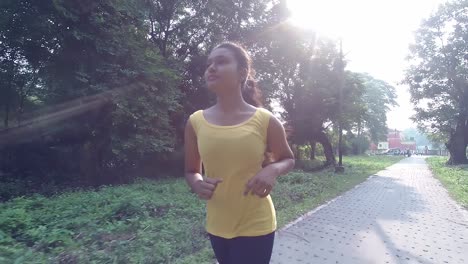 Young-Asian-girl-running-or-jogging-at-morning-or-evening-sunset-or-sunrise-in-nature