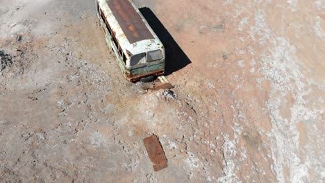 Aerial-drone-view-of-an-abandoned-bus-in-Atacama-desert,-South-America,-Chile
