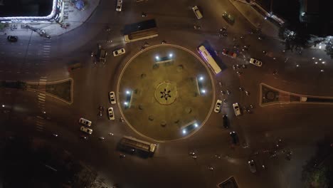 An-aerial-drone-shot-of-Rush-Hour-Traffic-at-Roundabout-Intersection-at-Night---Ascending