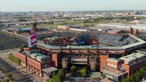 Aerial-turning-view-of-Citizens-Bank-Park,-home-of-Philadelphia-Phillies-with-city-skyline-view