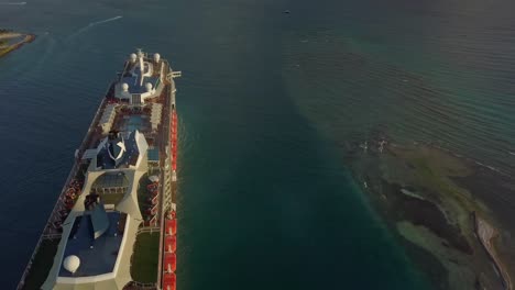 Aerial-sideways-fly-over-view-of-a-big-cruise-ship-close-to-the-coast-4K