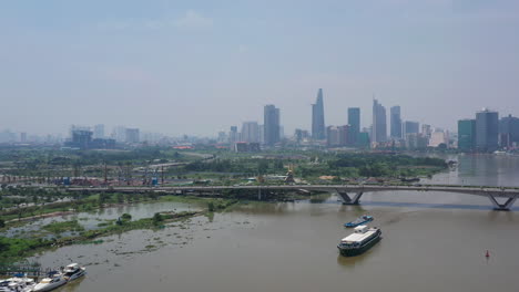 Aerial-shot-of-freighter-transporting-shipping-containers-on-the-Saigon-river-on-a-sunny-clear-day