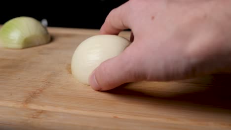 Cutting-onion-on-a-wooden-cutting-board