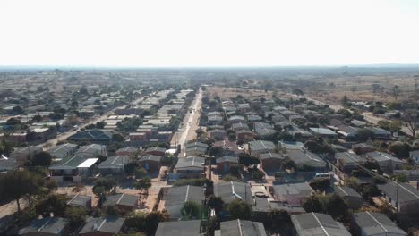 A-Pan-Right-Drone-Shot-of-Township-Housing-Complex-Under-Sunny-Conditions