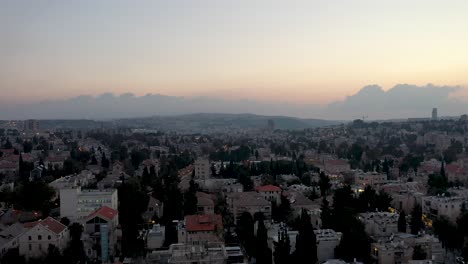Aerial-fly-down-shot-over-Jerusalem-Nachlaot-neighborhood-at-sunset,-Israel