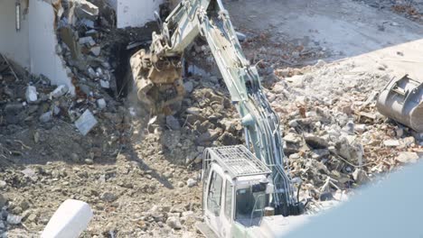 Condemned-building-being-torn-down-by-a-excavator